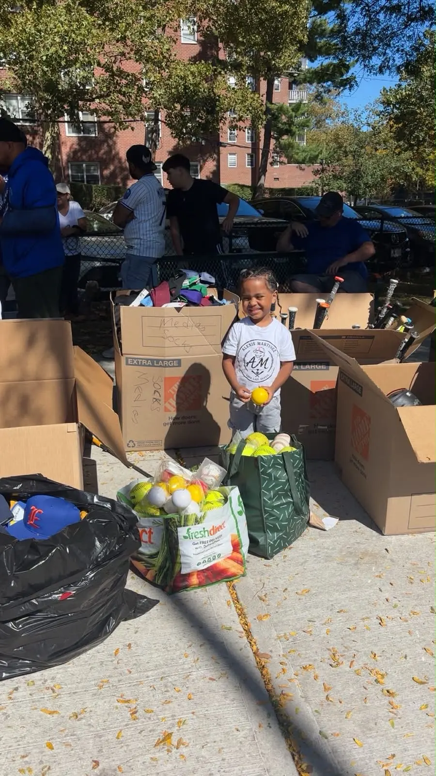 Young athlete holding donated baseballs