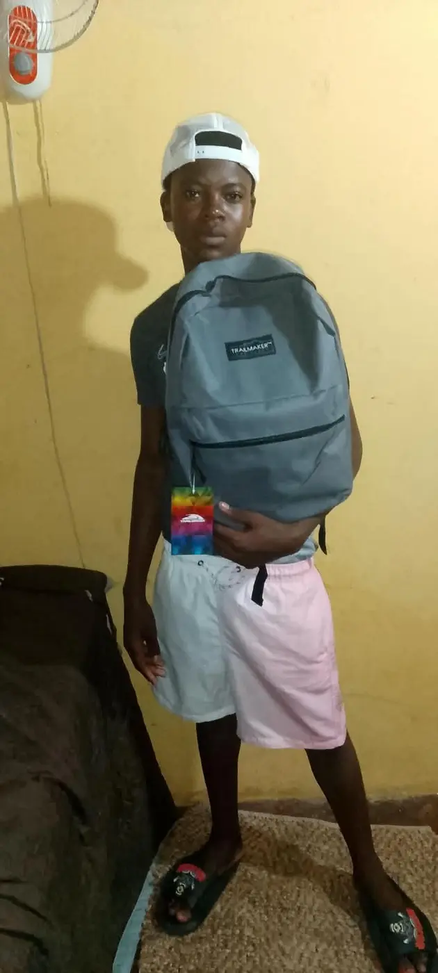 Young person receiving a new backpack