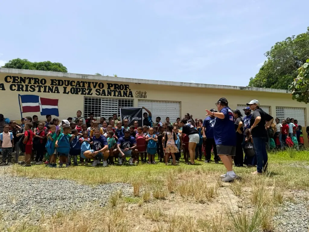 A large group of students gathered outside their school