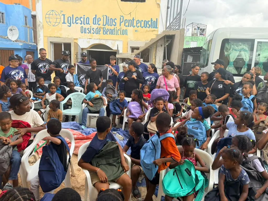Families and children celebrating the backpack distribution