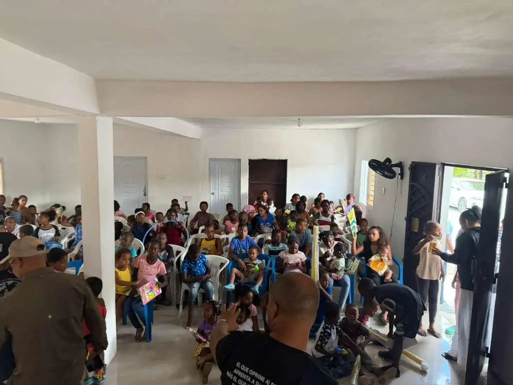 Children and families receiving toys at a community gathering